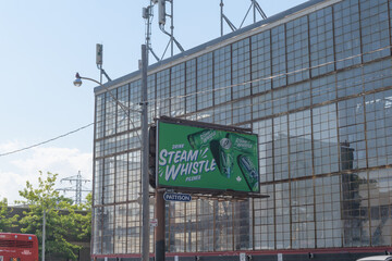 Obraz premium roadside billboard featuring advertising for Steam Whistle brewery, right by the old Hamilton Gear and Machine Company factory, 950 Dupont St at Dovercourt, Toronto
