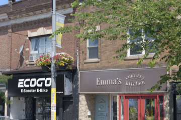 Obraz premium building facades and signs of ECOGO St Clair E-Scooter & E-Bike (812 St Clair Av W) and Emma's Country Kitchen (810 St Clair Av W), Toronto