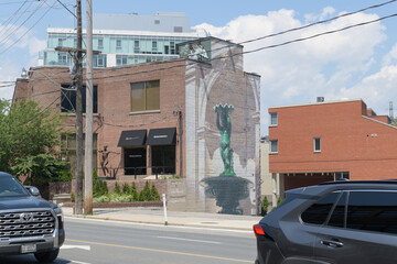 Obraz premium trompe du l’œil mural on the east facing wall of 314 Davenport Rd featuring a standing cherub statue-bird bath or fountain set in an architectural niche, Toronto