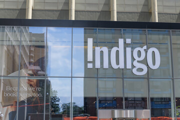 Obraz premium exterior building facade and sign of Indigo, a book store chain, located here at 55 Bloor St W inside Manulife Centre (Bay St side), Toronto