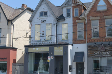 Obraz premium historic row houses and sign of Whyte Couture, a bridal shop, located at 133 Avenue Rd, Toronto