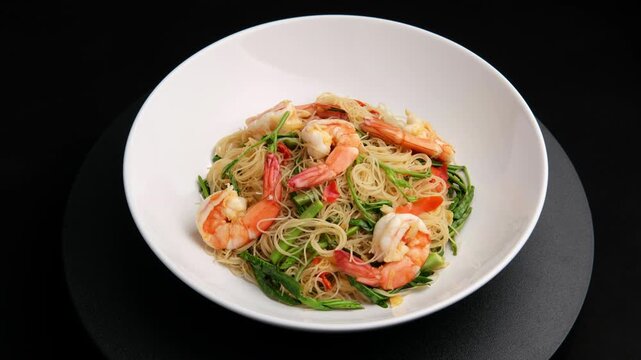 Stir Fried Rice Vermicelli with Water Mimosa and shrimp in white plate.Thai food.