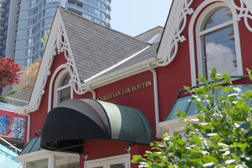Obraz premium historic house facade and sign of Christian Louboutin, a shoe store, located at 99 Yorkville Av, Toronto