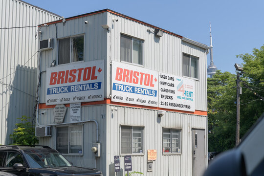 old building with signs at Bristol Car and Truck Rental Toronto (79 Nassau St, near Kensington Market)