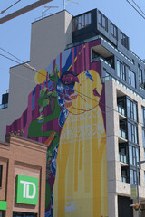 Obraz premium exterior building and corporate logo sign outside a TD bank branch located at 870 St Clair Av W; and huge mural art by Yasaman Mehrsa called 