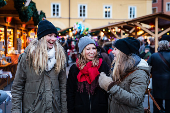Three young women enjoying a Christmas market festival