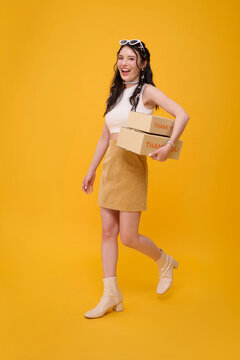 Asian woman carrying delivery boxes representing ecommerce fulfillment convenient online shopping customer satisfaction fast shipping small business service and modern retail logistics.