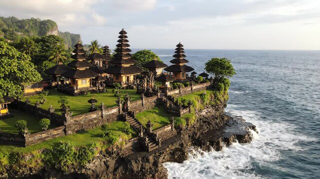 Pura karang bolong temple on a rocky cliff overlooking the ocean in bali, indonesia