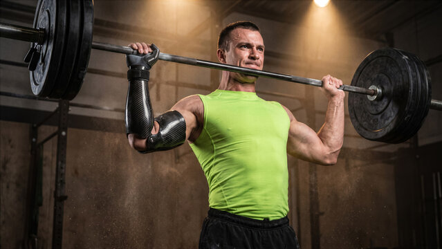 Adaptive powerlifter with bionic arm lifting heavy barbell overhead gym