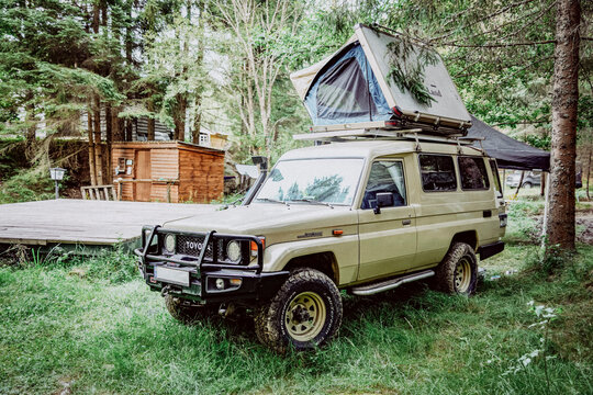 Image of an old Toyota Land Cruiser 78 camper in a camping site