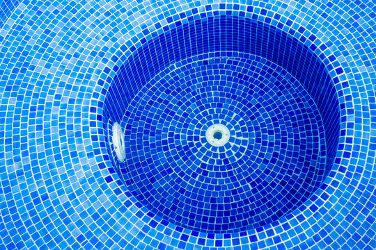 Bubbling Blue Pool Water Over Mosaic Tiles With Whirlpool Jets Creating Foam and Motion