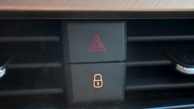 Blinking car hazard light button nest to door lock button.