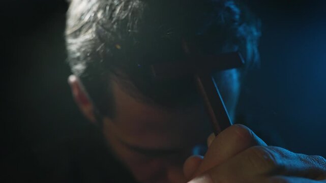 Man holding cross and touching it to forehead