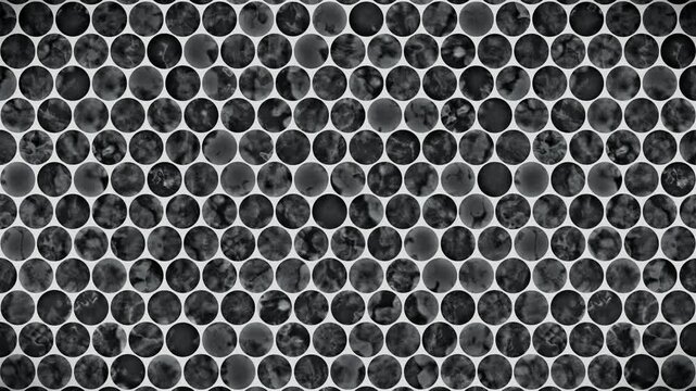 Abstract pattern background, dark grey circular tiles with mottled texture on a white backdrop, a seamless loop motion graphic