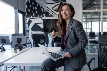 Stylish young business lady in the office looking positive and confident © zinkevych