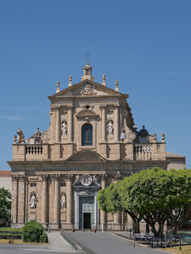 Church of Santa Teresa alla Kalsa in Palermo, Sicily. Majestic 17th-century Sicilian Baroque church facade with ornate stone columns and statues under a bright blue sky.