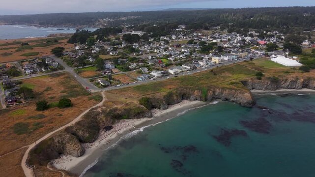 Explore the stunning town of Mendocino, California featuring aerial views of its coastline and a music festival tent nearby.