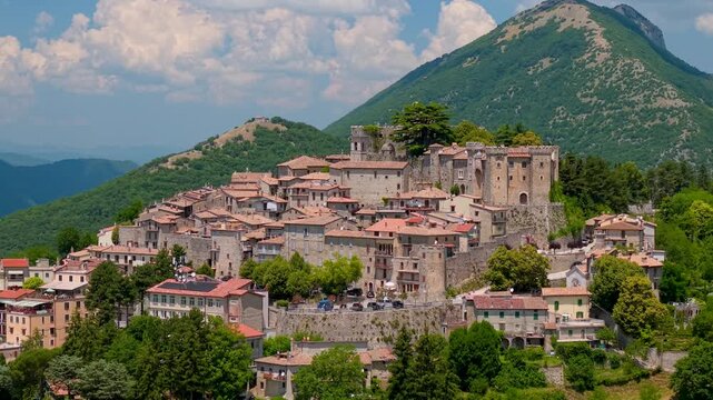 Collalto Sabino Italy 70mm drone view of medieval hilltop borgo castle town. Cinematic close up flight with big mountain background of Baronale fortress in Rieti Lazio b-roll stock video