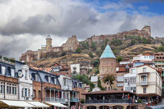 View of Narikala fortress, and Tbilisi old town, Georgia, panoramic cityscape. Overcast weather with cloudy sky