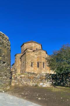 Jvari Monastery near Mtskheta, Georgia, featuring an ancient tetraconch apse facade. Sunny day with clear blue sky
