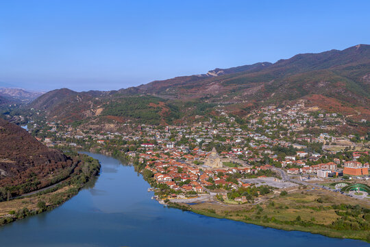 Panoramic view of Aragvi and Kura rivers confluence near Mtskheta Georgia from Jvari Monastery hill. Sunny day with blue sky