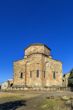 Jvari Monastery near Mtskheta, Georgia, featuring an ancient tetraconch apse facade. Sunny day with clear blue sky