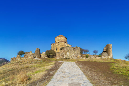 Jvari Monastery on a hilltop near Mtskheta, Georgia, early medieval stone architecture. Sunny day with clear blue sky