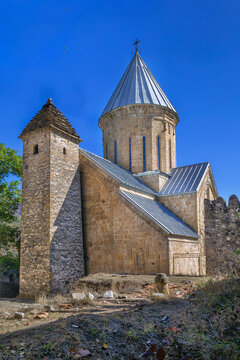 Church of the Mother of God in Ananuri Fortress, Georgia, with an adjacent medieval defense tower. Sunny day with blue sky
