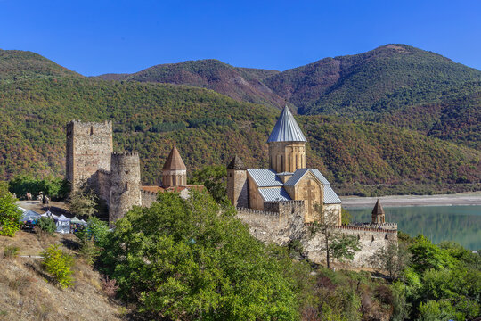View of Ananuri Fortress on the Aragvi River, Georgia, majestic medieval landscape. Sunny day with bright blue sky