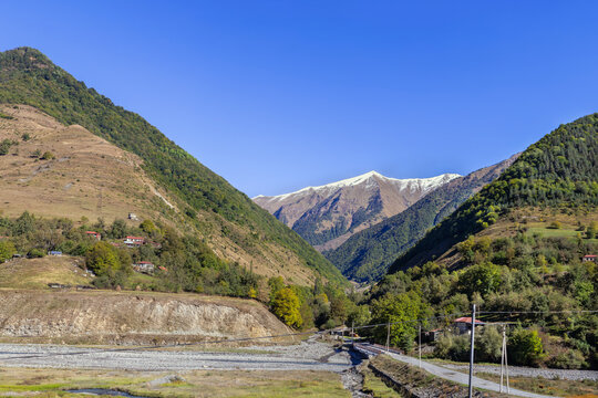 Landscape with mountains in Aragvi Valley along the Georgian Military Road, Georgia. Sunny day with bright blue sky