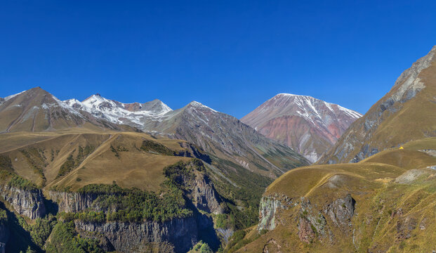 Mountain landscape near Gudauri from Georgia-Russia Friendship Monument, Georgia. Sunny day with bright blue skyм