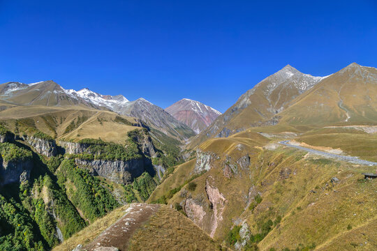 Caucasus mountain peaks near Gudauri in Georgia, majestic alpine highland landscape. Sunny day with bright blue sky