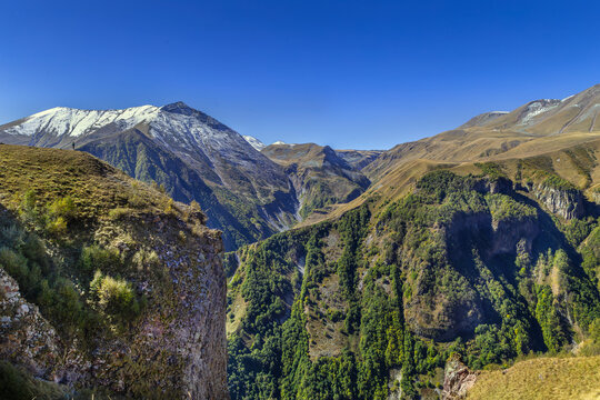 Caucasus mountain peaks near Gudauri in Georgia, majestic alpine highland landscape. Sunny day with bright blue sky