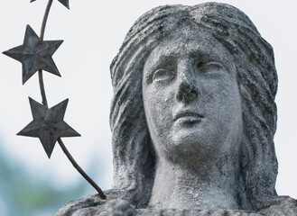 Fototapeta premium Ancient stone angel statue with a crown of stars, symbolizing hope, guidance, faith and divine protection.