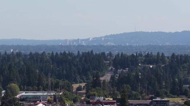Aerial of suburban landscape with forested hills and distant downtown Portland city skyline from Hazel Dell Washington