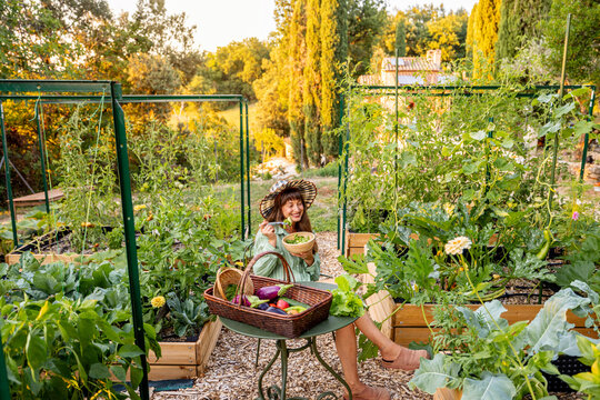 Woman Enjoying Fresh Garden Salad in Raised Vegetable Garden