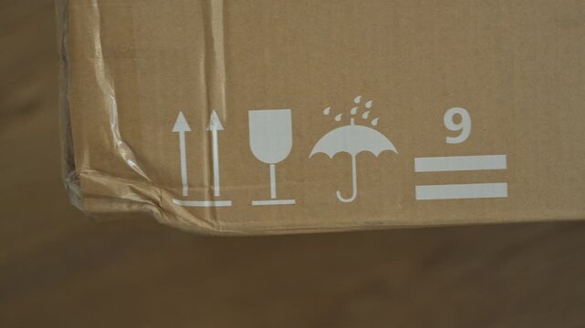 Recycling sign printed brown cardboard packaging background White symbol emphasizing sustainable materials eco friendly shipping solutions commercial green marketing campaigns macro detail paper box w