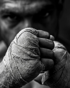 Black and White Boxing Fighter Training: Focus, Power, and Determination - Close-Up Portrait of Strong Male Athlete