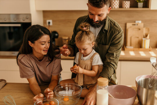 Happy family cooking together enjoying kitchen activity