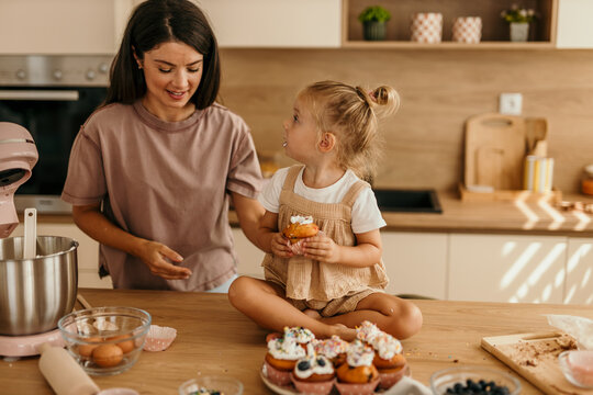 Mother and daughter baking together in kitchen