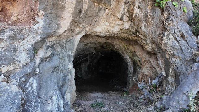 Close-up view of entrance to German World War II military cave shelter carved into rocky hillside. Greece. Crete.