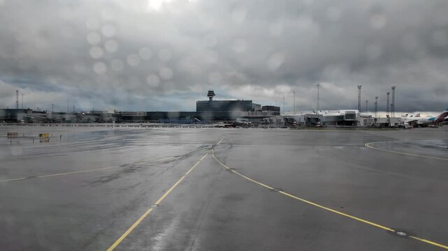 Beautiful view of rainy airport apron and terminal through airplane window before departure. Sweden. Stockholm. 