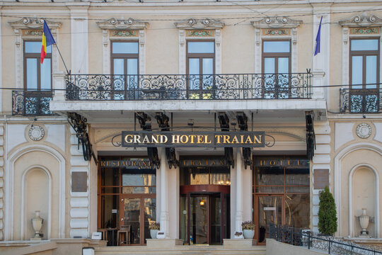 Front entrance of the historic Grand Hotel Traian in the center of Iasi, featuring elegant architecture, Romanian and European Union flags - Iasi, Romania - April 05, 2026