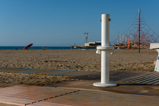 White public beach shower with sea and blue sky