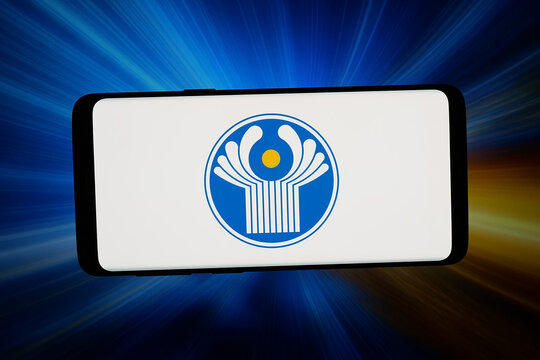 Stuttgart, Germany - 07-10-2026: In this photo illustration, the logo of Commonwealth of Independent States (CIS) is displayed on a smartphone in front of abstract background on computer screen.