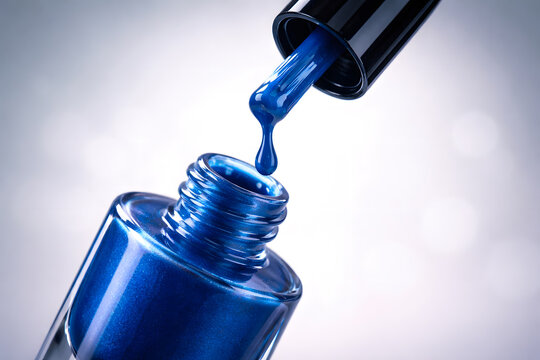 Blue Nail Polish Dripping from Brush Over Open Glass Bottle Close-Up