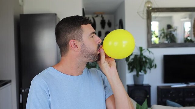 A man who is feeling bloated holds inflatable balloon 