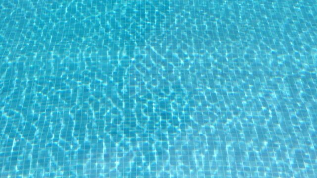 Clear turquoise water with sun glare and wavy ripple pattern