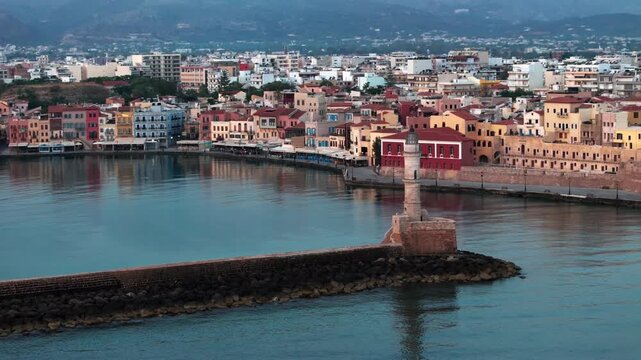  View of Chania with the amazing lighthouse, mosque, venetian shipyards, Crete, Greece.Waves crashing on lighthouse, Beautiful Greece and best scenic places - panorama
