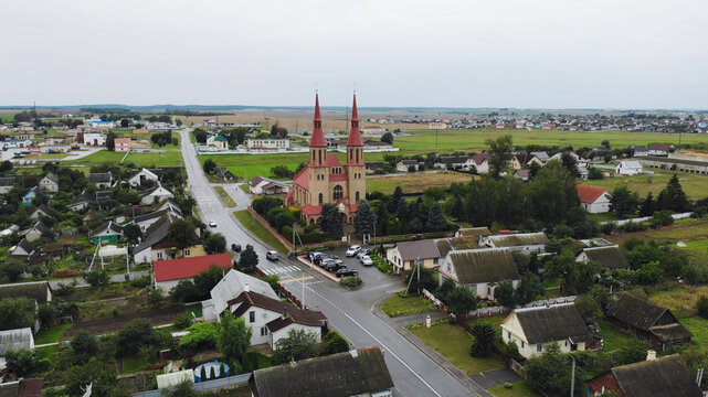 Elevated view revealing a vibrant church complex within a small rural settlement